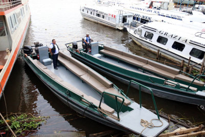 OUR SKIFFS WAITING TO TAKE US THE BOAT