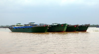 Boats waiting to be loader with sand on the Mekong River