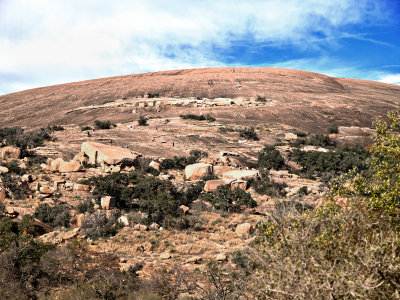 The Rock with hikers scatterd about. How many hikers can you find?  See next image.