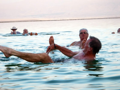 Dave and Garry floating in the dead sea at sunset