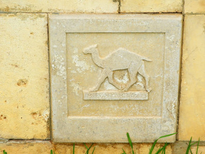 Brick in the cemetery wall depicting the Camel Corps