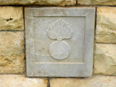 Brick in the cemetery wall depicting different regiments