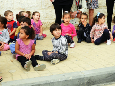Children waiting to see the procession of horses and their riders