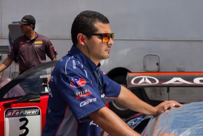 Acura Team Mechanic watching over their car.