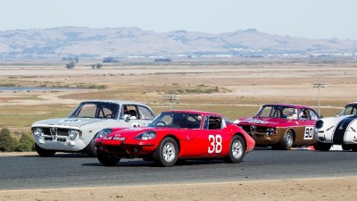 A Marcos 2 Alfas and a Porsche in turn two at Sonoma.