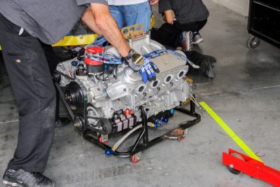 A NASCAR engine getting ready to replace a blown motor.
