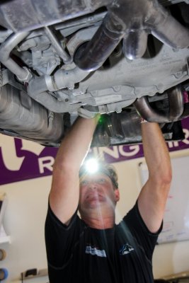Working underneath a Porsche.