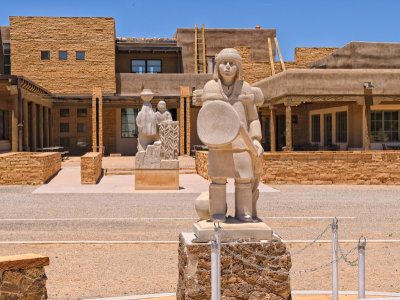 A young brave facing the Acoma mesa with the Cultural Center in the background.