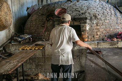 Putting bread in the horno