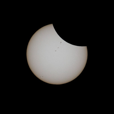 Partially-eclipsed sun, with sunspots