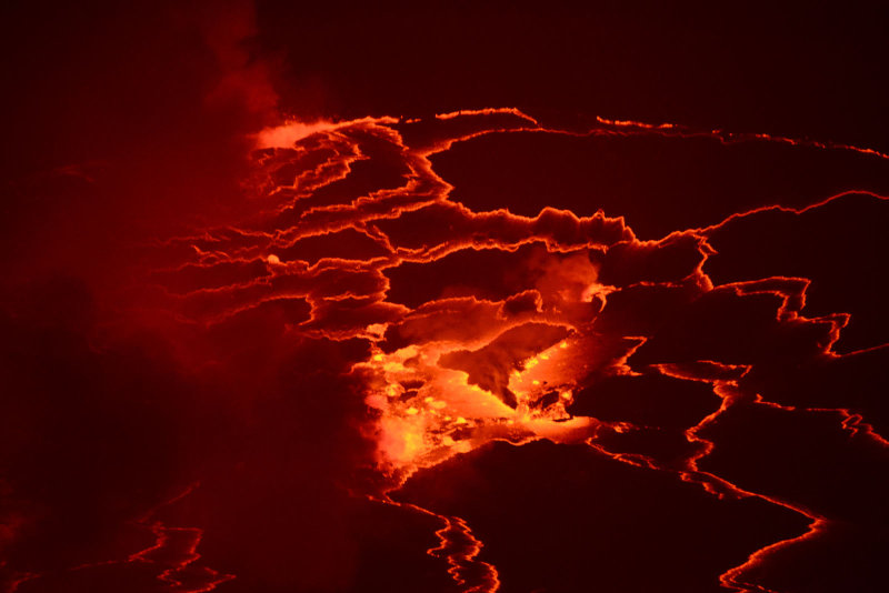 A portion of the crusted surface of the lava lake breaks apart and a large area of molten lava appears