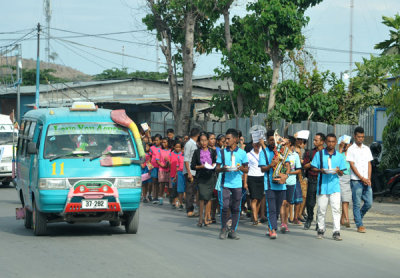 Religious procession of young people along the road between Dili and Tasi Tolu