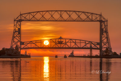 96.71 - Duluth Harbor:  Fog With Sun Rising Behind Aerial Lift Bridge 