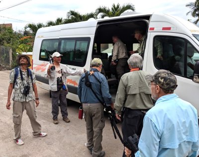 Kannan looks for one more bird while Lelis holds the door and Michael, David and Allan get ready to board the van.