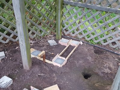 The ground was soft under the trellis and I dug the holes with a garden trowel after measuring and marking them in each direction.