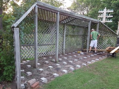 I started at the N end and cut one of the four-by-fours to fit along the angle of the trellis. I had also decided to use a 1 x 6 board upright between the joist and the trellis to discourage varmints from getting under the deck.