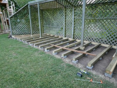 I marked all the joists by the string pulled across the front of the trellis and cut them to length, but my inaccurate marking, cutting, etc. required me to use shims on a few of them when it came time to apply the 1 x 6 pieces across the front.