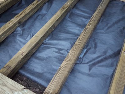 I stapled the yard cloth to the beams, hoping to seal off all light.