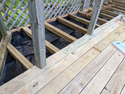 Detail of deck boards notched around two of the trellis posts