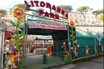 Little closed park where street curves toward the sea