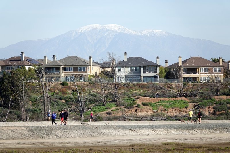 Shorts and shirt sleeves in the foreground, and snow in the mountains in the background