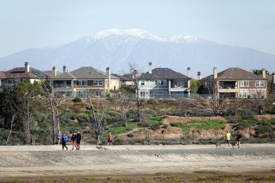 Shorts and shirt sleeves in the foreground, and snow in the mountains in the background