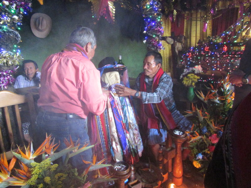 Giving offerings of alcohol to Maximon