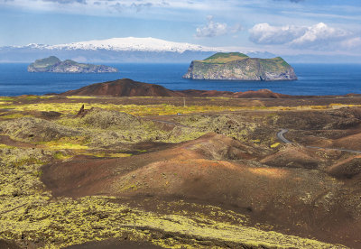 The view of the islands of Elliðaey and Bjarnarey from the extreme side of the new land created by the 1973 eruption on the island of Heimaey, Vestmannaeyjar (the Westman Islands), Iceland.
In the distance is visible, on Iceland mainland, Eyjafjallajökull, the Glacier of the Islands, that takes its name from the Vestmannaeyjar. at Bjarnarey there is a lodge ,while at Elliðaey (left ) there is a mystery of one of the world's loneliest house on remote island that has been empty for over 100 years