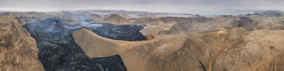 Panoramic photo from the eruption site in South  Iceland ,all the way to the right ,you can see the beginning of the village Grindavic ,the parking lot ,the 427 road , the start point to the hike up to volcano and the artificial dam .The eruption continues to produce lava flows at constant pace, which gradually both enlarge and thicken the expanding lava flow field .