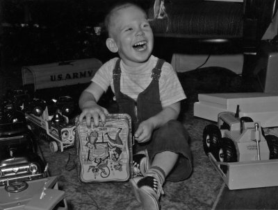 1954 - 1957 Chistmas 1957 - Greg with Christmas presents.jpg