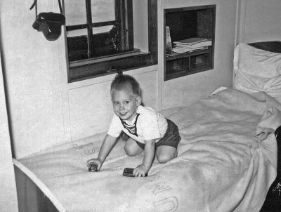 1954 - 1957 Kenya Castle - Greg playing on bed.jpg