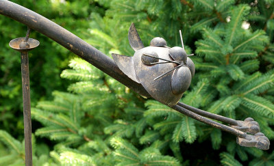 Balancing cat sculpture.