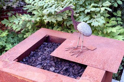 Fire pit with bird sculpture.