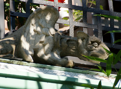 Gargoyle crouching on roof.