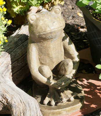 Seated frog sculpture.