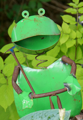 Frog on bicycle sculpture.
