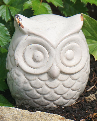 White ceramic owl sculpture.