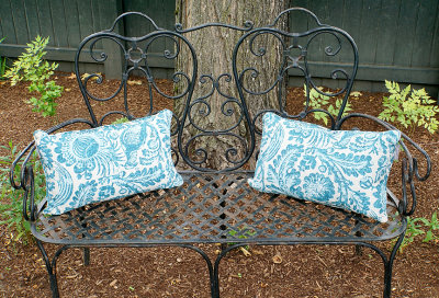 Metal bench with pillows.
