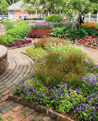 Flower beds with brick walks.