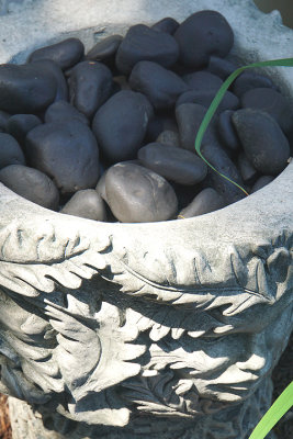 Urn with black stones.
