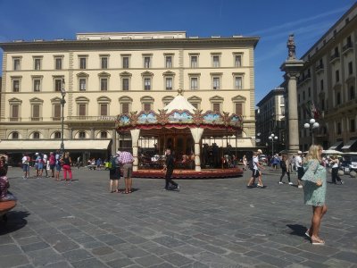 Piazza della Republica with early 20th century carrousel and 15th century Colonna della Dovizia marking the main Roman streets 