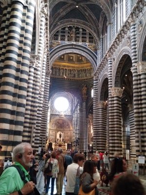 Inside the church is unique with a forest of striped columns and a row of 172 popes peering down