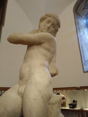 No one is sure whether it's supposed to be David reaching for his sling or Apollo reaching for an arrow