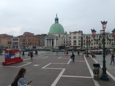First view of Grand Canal exiting train station. The green dome of San Simeone Piccolo church with St. Simeon on top waving Ciao
