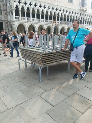 Acqua Alta(very high tides) affect St Mark's Square first. Stacked wooden benches placed end to end create an elevated sidewalk