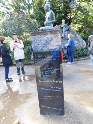 The Oscar Wilde Sculpture- a pillar with a bronze of his pregnant wife, Constance, staring accusingly across the path at him