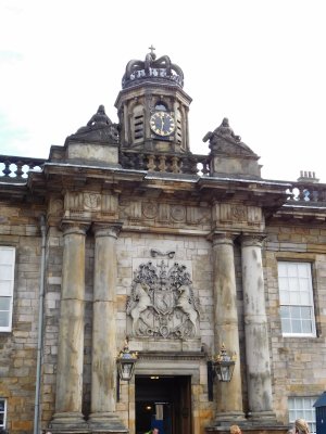 The entry gateway framed by coupled Roman Doric columns, the carved Royal Arms of Scotland & octagonal cupola with clock-face