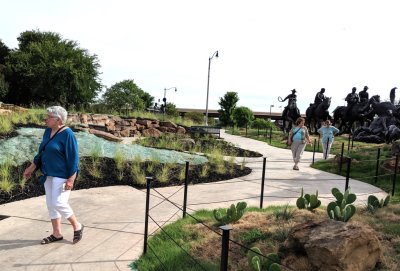 Ann, Mary and Carolyn strolling the sidewalk around the Land Run sculpture in OKC