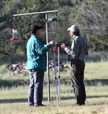 After having all the feeders open for a while, Kelly (L) and Mike (R) put a cage around one of the feeders.