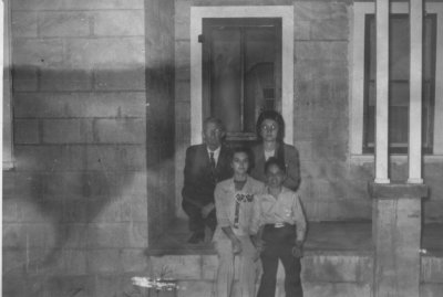 MA and Rudel Harris (in back) and Jackie and Pepper Howard on the porch of of Euritt and Helon Davis' house on SW 31st, OKC, before the rock facia was put on the Davis house
